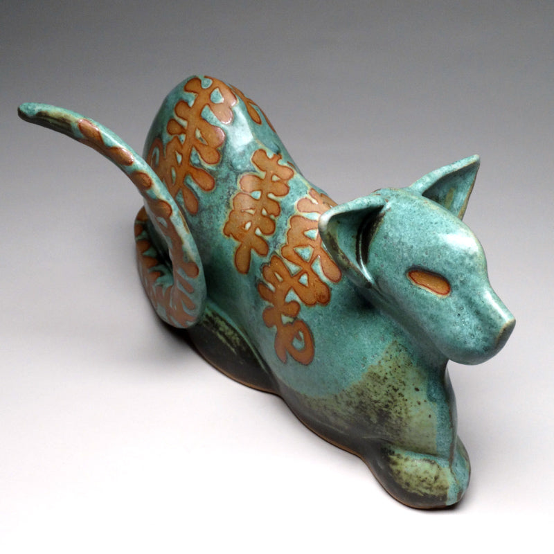 Crouching Cat in Green with Ferns